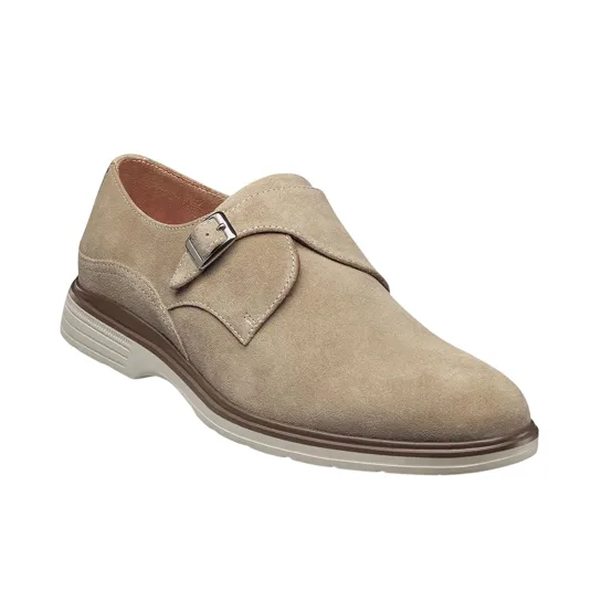 A tan suede monk strap shoe with a metal buckle and a contrasting sole, featuring a combination of casual and formal design elements.