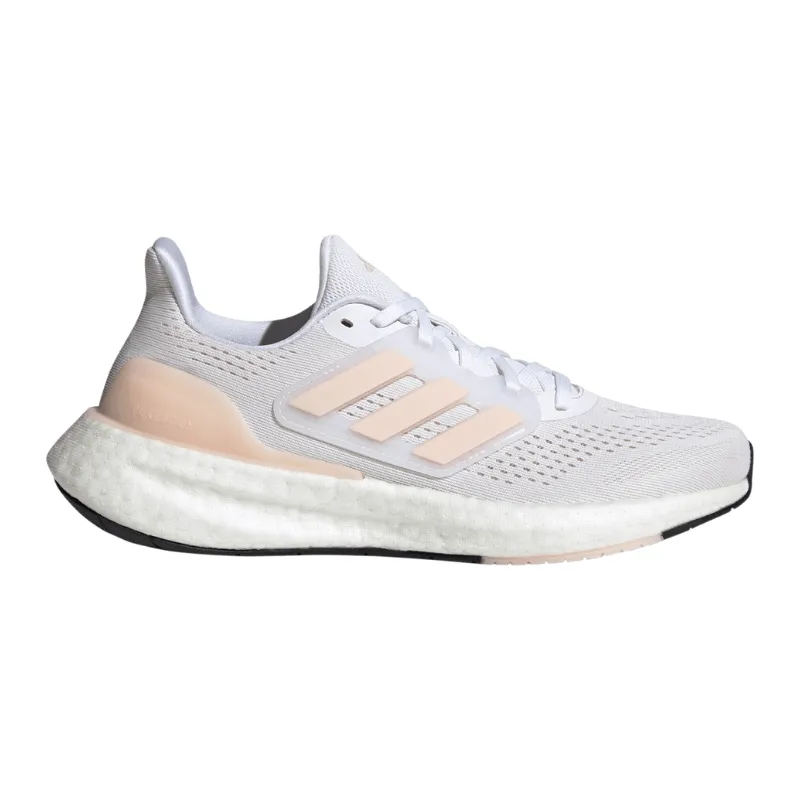 Adidas Pureboost 23 Running Shoes feature a white upper with soft pink stripes, a thick white Boost midsole for comfort, and a black outsole, designed for running performance and style.