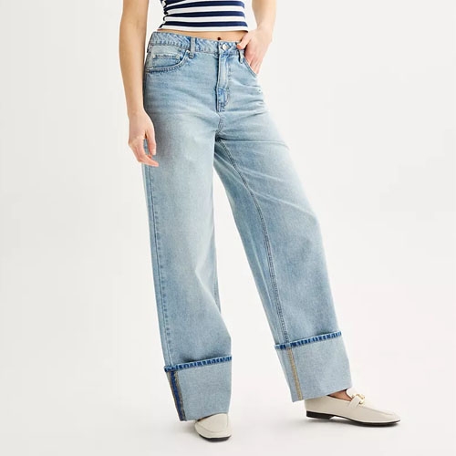 a person wearing light blue wide leg jeans with a striped crop top and beige loafers