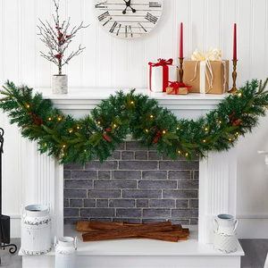 6' Pre-Lit Holiday Garland is a festive green decoration with pinecones, red berries, and warm white lights. It drapes elegantly on a white fireplace mantel, complementing wrapped gifts and candles.