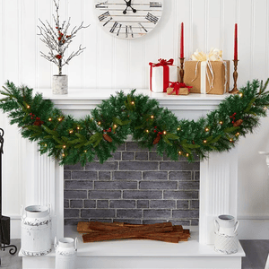 6' Pre-Lit Holiday Garland is a festive green decoration with pinecones, red berries, and warm white lights. It drapes elegantly on a white fireplace mantel, complementing wrapped gifts and candles.