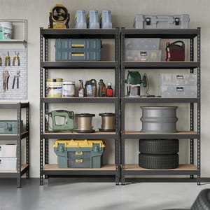A garage shelf holds various tools and supplies, including a yellow and gray toolbox, a fan, power tools, containers, bottles of oil and chemicals, spools of wire, and stacked tires.