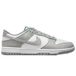 A pair of gray and white low-top sneakers with suede and leather details, featuring the Nike logo on the sides.