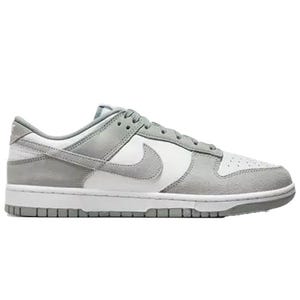 A pair of gray and white low-top sneakers with suede and leather details, featuring the Nike logo on the sides.