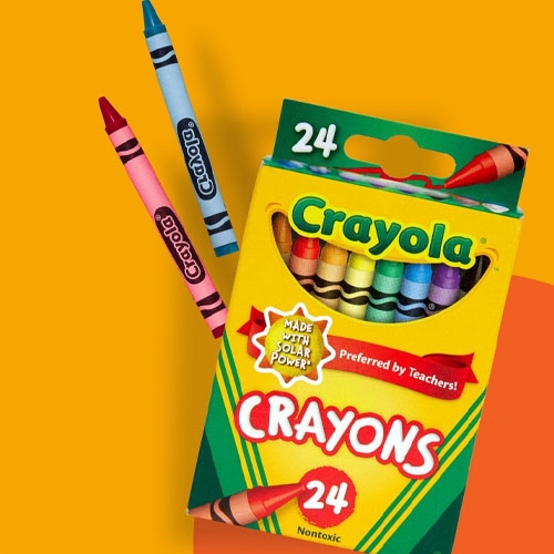 A box of 24 Crayola crayons with a couple of crayons lying beside it.