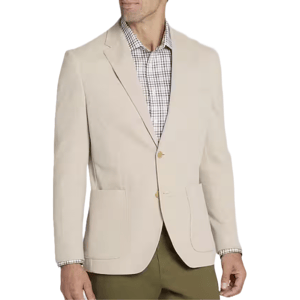 A man wearing a beige blazer over a checkered shirt with olive green pants.