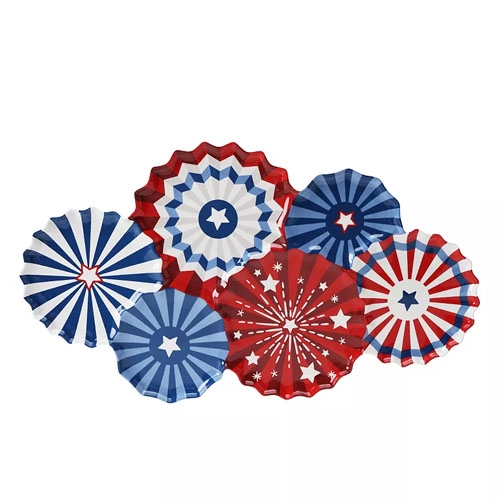 The Americana Patriotic Fan Shaped Platter features a set of colorful plates in red, white, and blue with star and stripe patterns, resembling fireworks or decorative fans.