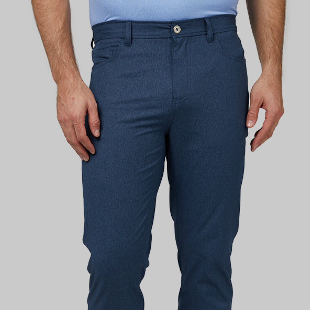 A man is wearing blue trousers and a light blue tucked-in shirt.