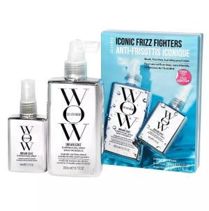 A set of three Color Wow Dream Coat hair products, including two larger bottles and one smaller spray, aimed at combating frizz, are displayed alongside their packaging.