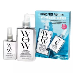 A set of three Color Wow Dream Coat hair products, including two larger bottles and one smaller spray, aimed at combating frizz, are displayed alongside their packaging.
