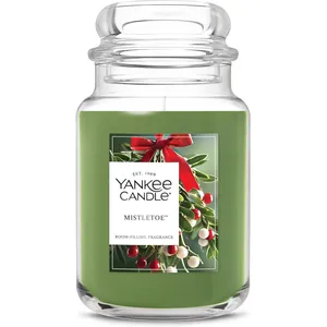 Yankee Candle Mistletoe, a green jar candle featuring a room-filling fragrance, with festive mistletoe imagery and a red ribbon.