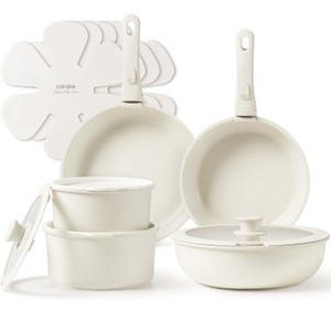 The Carote Detachable-Handle Cookware features two frying pans and three pots with lids, along with felt protectors. All items are white with speckled designs, offering versatility and easy storage due to the detachable handles.