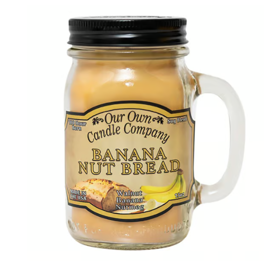 Our Own Candle Company Banana Nut Bread scented candle in a mason jar with a handle, featuring notes of walnut, banana, and nutmeg.