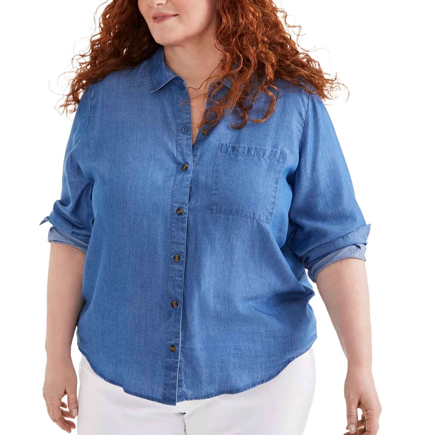 A person is wearing a blue denim button-up shirt with rolled-up sleeves and white pants.