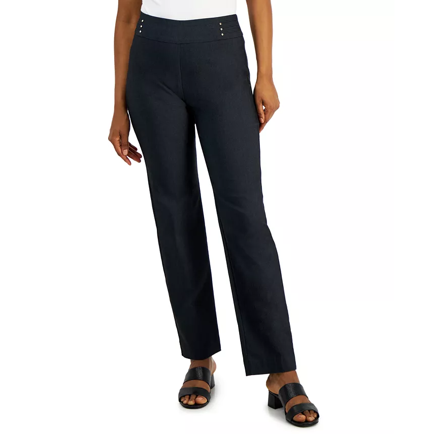 A person wearing dark trousers and black open-toed sandals.