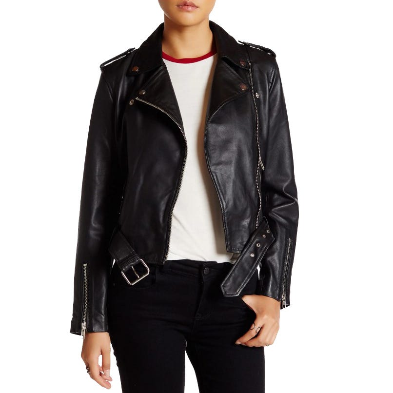 A person wearing a black leather biker jacket over a white top paired with black jeans.