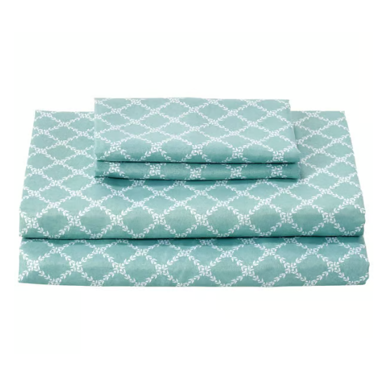 A set of teal-colored bed sheets with a white geometric pattern, including a fitted sheet, a flat sheet, and pillowcases.