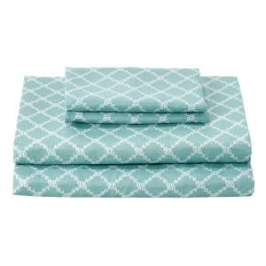 A set of teal-colored bed sheets with a white geometric pattern, including a fitted sheet, a flat sheet, and pillowcases.