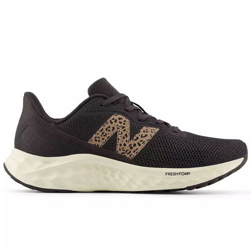Black athletic shoe with a leopard-print \“N\“ logo and a white, cushioned Fresh Foam midsole.