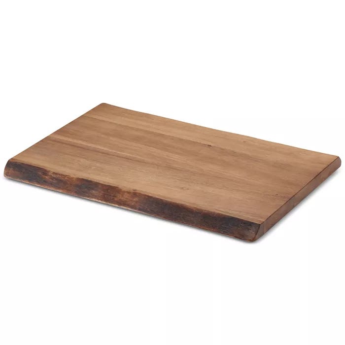 This is a rectangular wooden cutting board with a natural finish and slightly darker edges, likely designed for kitchen use.