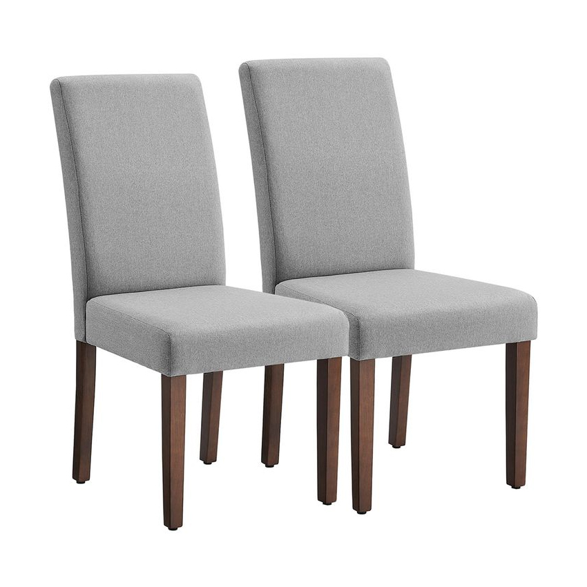 Two dining chairs with light grey upholstered seats and backs, supported by dark wooden legs.