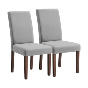 Two dining chairs with light grey upholstered seats and backs, supported by dark wooden legs.