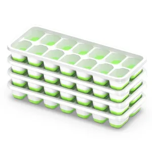 A stack of four white silicone ice cube trays with green lids, each tray has multiple compartments for ice cubes.