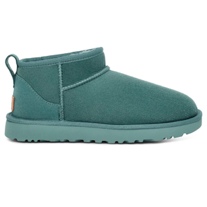 A teal ankle-high suede boot with a round toe, flat sole, and rear pull tab, featuring visible stitching details.