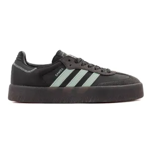 A black Adidas Samba sneaker with mint green stripes, thick black sole, and a textured toe area.