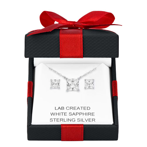 A jewelry set featuring a lab-created white sapphire pendant necklace and matching earrings in sterling silver, presented in a black and red gift box.