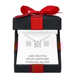 A jewelry set featuring a lab-created white sapphire pendant necklace and matching earrings in sterling silver, presented in a black and red gift box.