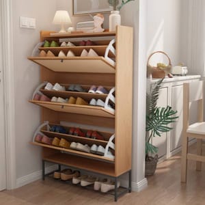 A wooden shoe rack with multiple tiered shelves neatly holds various pairs of shoes. The top also features a small lamp and decorative items.