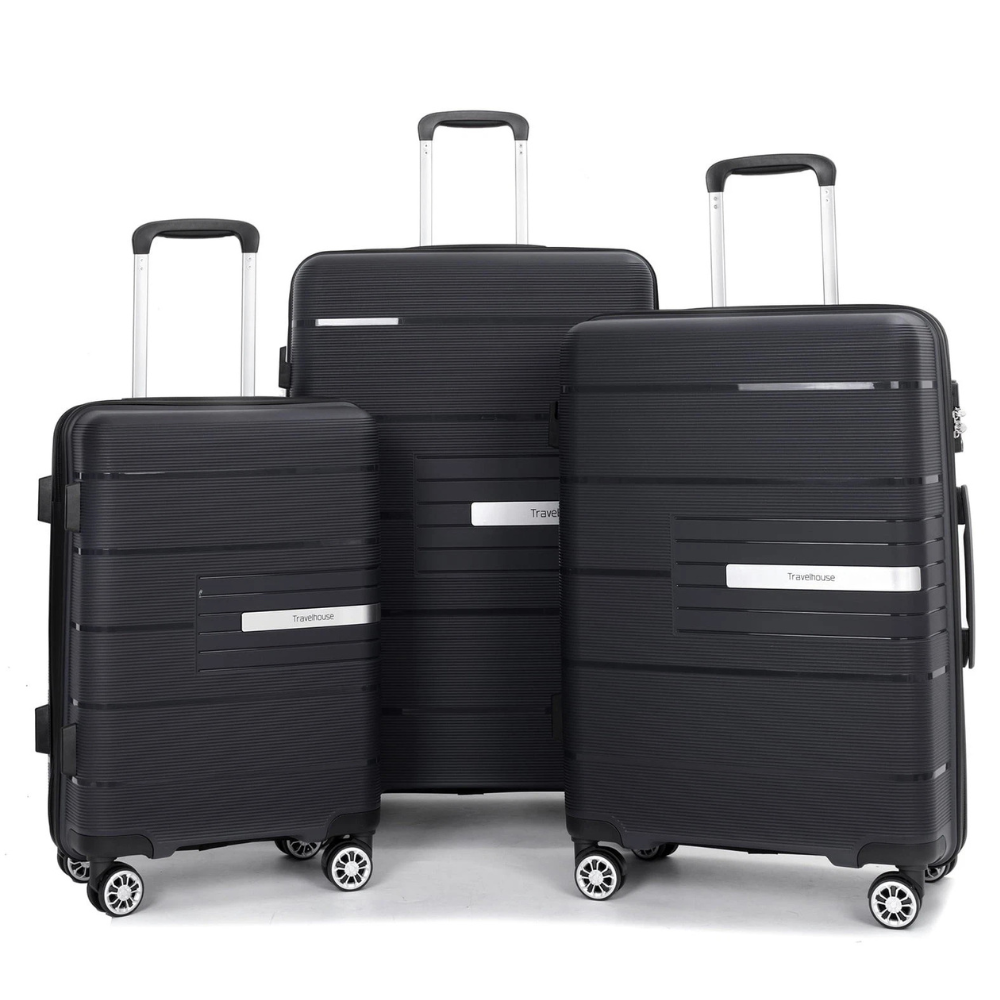 Three black suitcases in varying sizes with telescopic handles and spinner wheels, featuring horizontal grooves and a metallic brand plate reading \“Travelhouse.\“