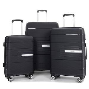 Three black suitcases in varying sizes with telescopic handles and spinner wheels, featuring horizontal grooves and a metallic brand plate reading \“Travelhouse.\“