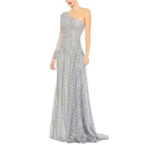 A silver, one-shoulder evening gown featuring an intricate geometric pattern and a fitted, flowing silhouette.