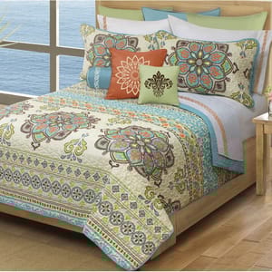 Colorful quilted bedding set with matching pillows, featuring bohemian patterns.