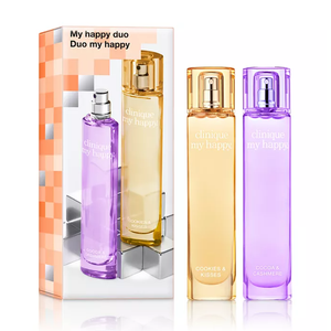 Clinique My Happy Duo includes two perfumes: \“Cookies & Kisses\“ with a warm, amber scent, and \“Cocoa & Cashmere\“ featuring a sweet, cozy fragrance. Each perfume comes in a sleek, colorful bottle.