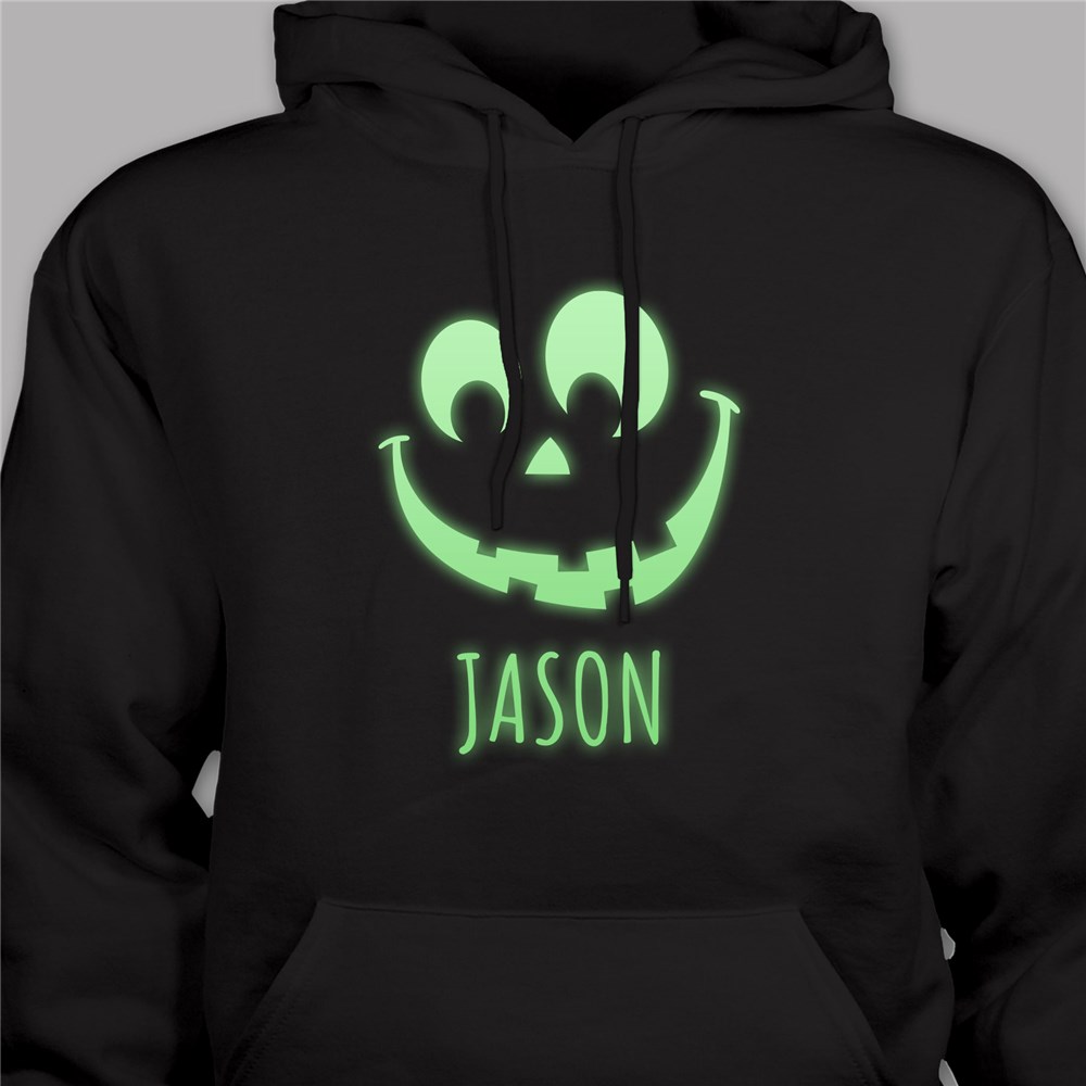 Black hoodie with a glowing green jack-o'-lantern design and the name \“JASON\“ below it.
