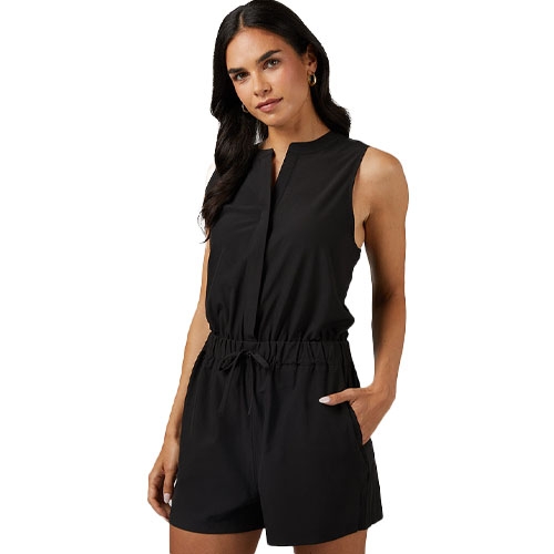 A woman is wearing a sleeveless black romper with a drawstring waist.