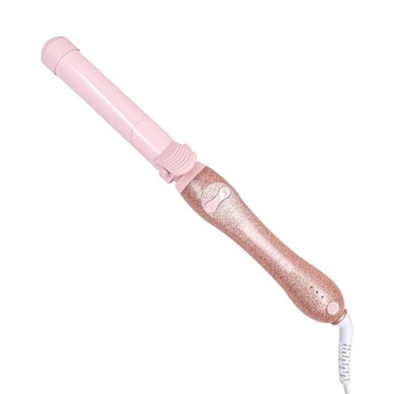 Pink and rose gold curling iron from Beachwaver with a 1.25-inch barrel, glittery handle, and built-in clamp.
