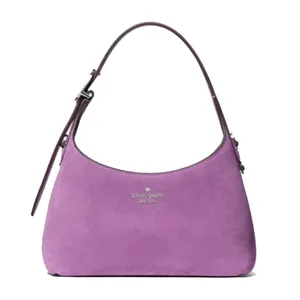 Purple suede handbag with a single adjustable strap and the \“kate spade new york\“ logo on the front.