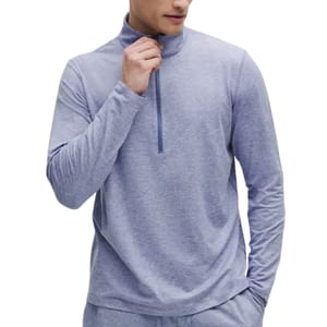 A person is wearing a light blue long-sleeve quarter-zip top.