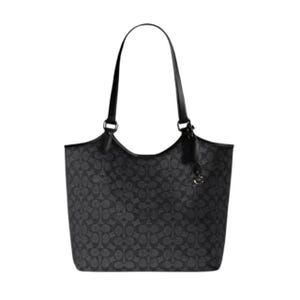A black tote bag with a monogram pattern, featuring dual shoulder straps and a decorative charm.