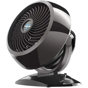 A Vornado air circulator fan featuring a sleek black design with a round, tiltable head and a control dial on the base.