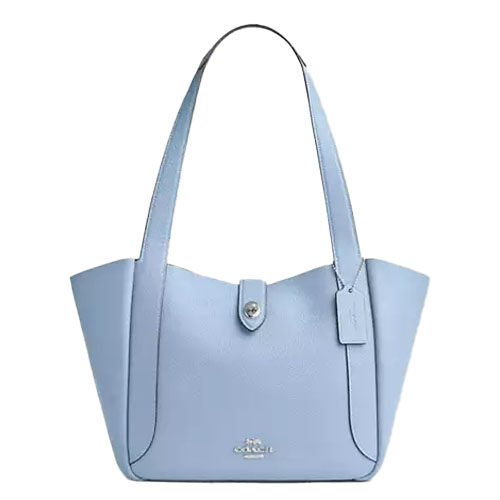 Light blue leather tote bag with a streamlined design, featuring a turnlock closure and two shoulder straps. Includes a small hanging tag and subtle brand logo on the front.