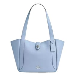 Light blue leather tote bag with a streamlined design, featuring a turnlock closure and two shoulder straps. Includes a small hanging tag and subtle brand logo on the front.