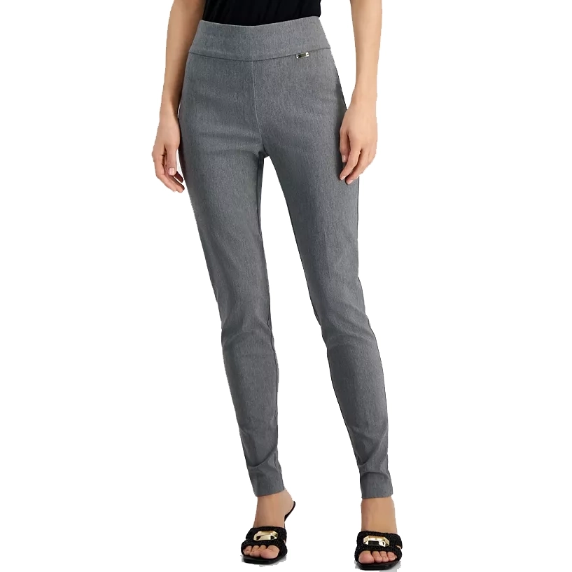 A person wearing gray slim-fit trousers and black sandals with gold-tone buckles.