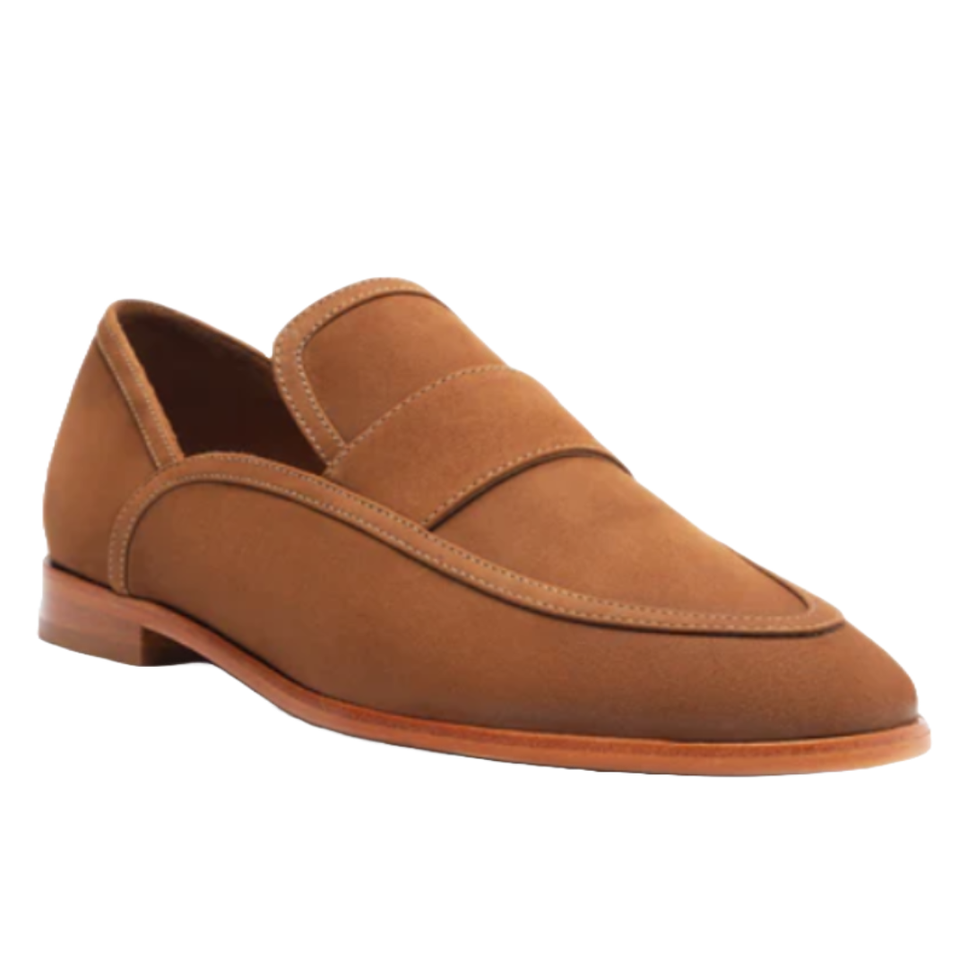 Maurice Nubuck Flats are tan suede loafers with a clean, minimalist design. They feature a penny strap detail and a wooden sole, offering a classic and elegant look.