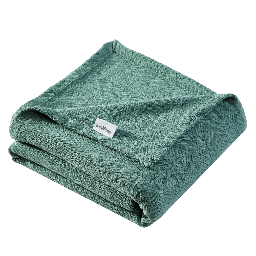 A folded green herringbone-patterned blanket with a visible fabric tag.