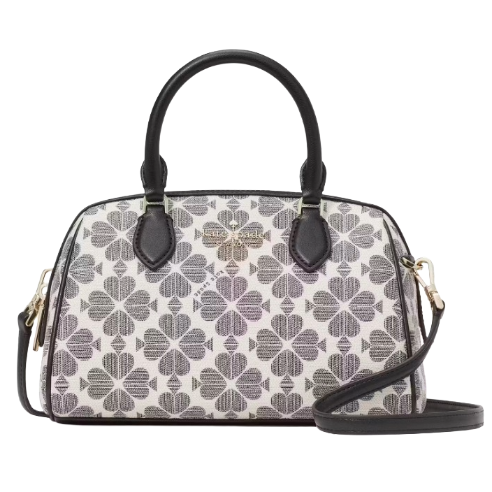 A handbag with a floral pattern in shades of gray and black, featuring dual handles and a detachable shoulder strap. The brand name is displayed on a metal plate on the front.
